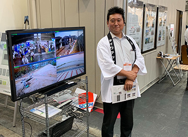 photo of a Daiwatech member in front of our booth